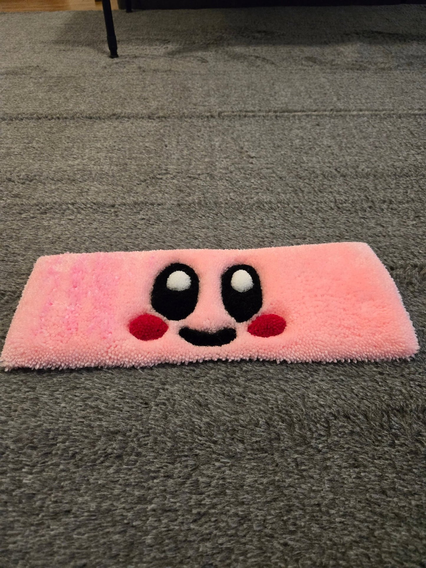 Cute Kirby Keyboard custom tufted premium rug laying on carpet- low view