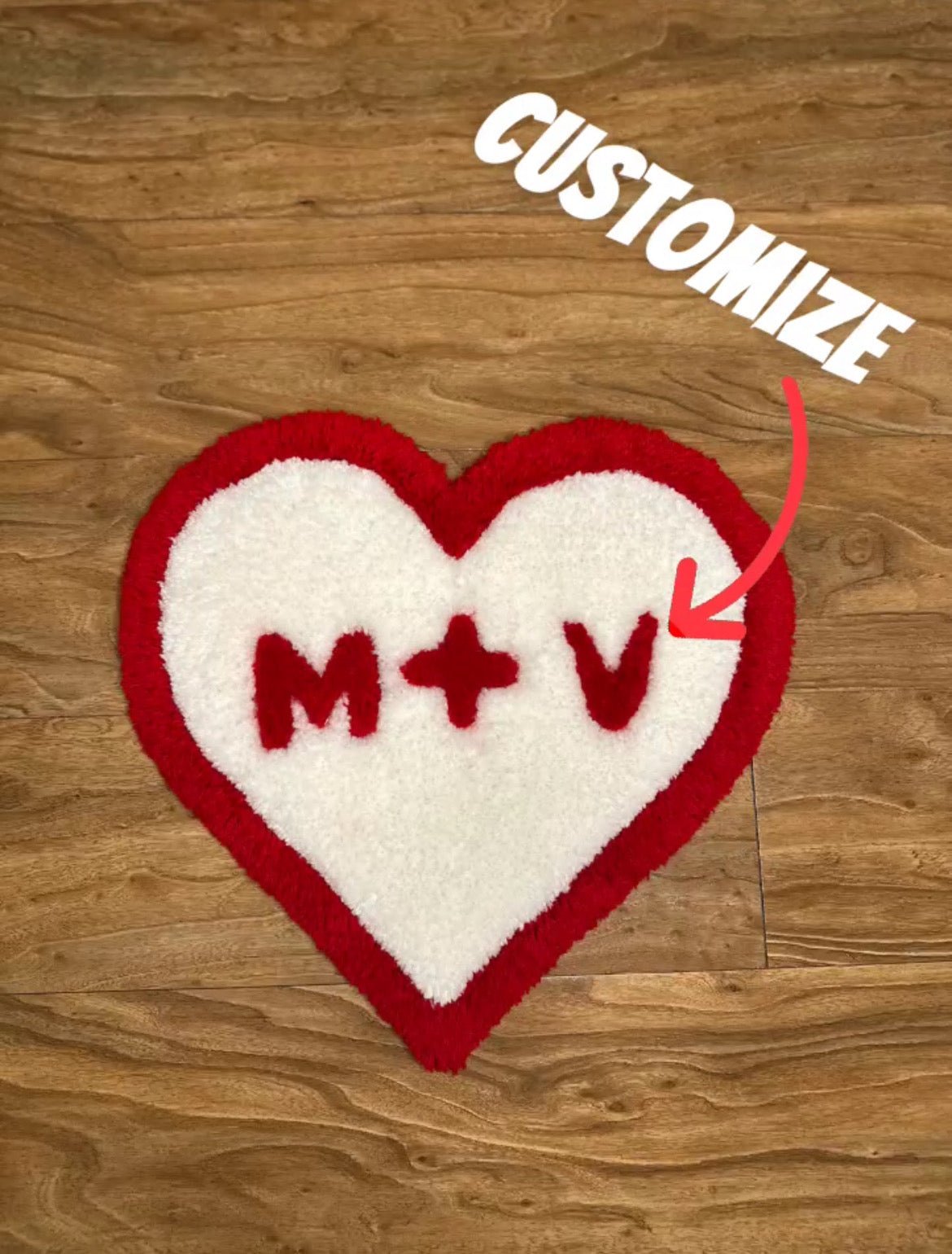 Medium sized Valentines Heart custom tufted premium rug with custom initials laying on wood floor - top view