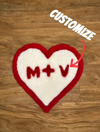 Medium sized Valentines Heart custom tufted premium rug with custom initials laying on wood floor - top view